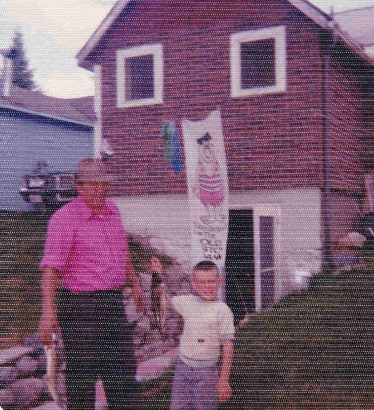 Young Don with his dad outside the cottage at Doe Lake