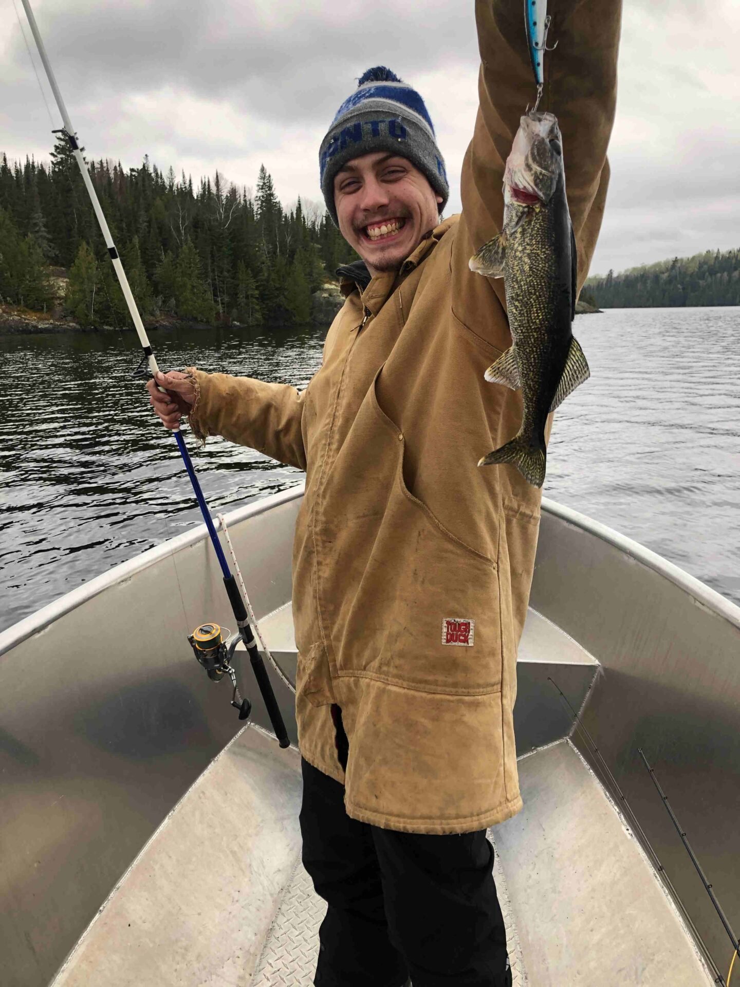 Devin with a smaller walleye after a week of big fish on Dog Lake
