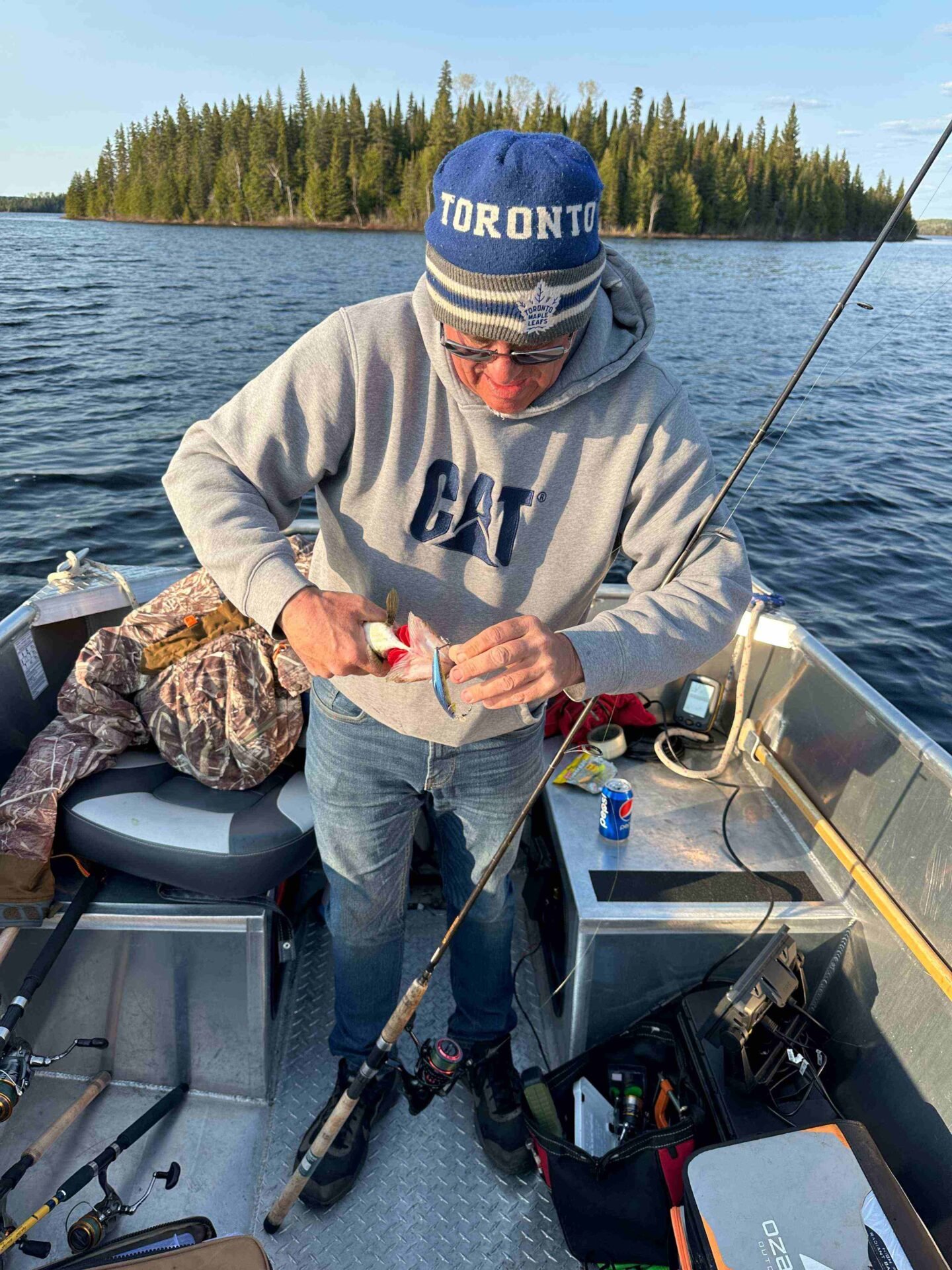 Don unhooking his first walleye of the week on Dog Lake at golden hour