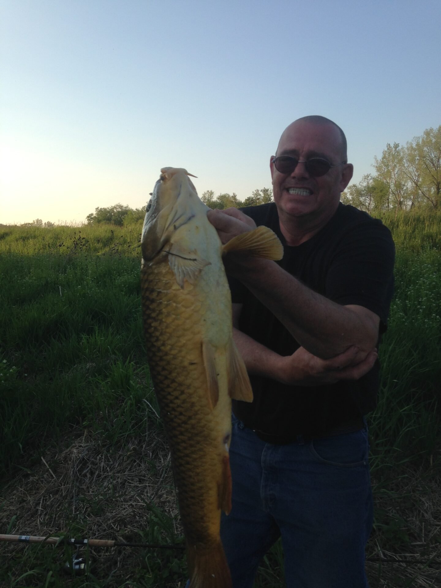 Don holding a large carp caught on the Grand River