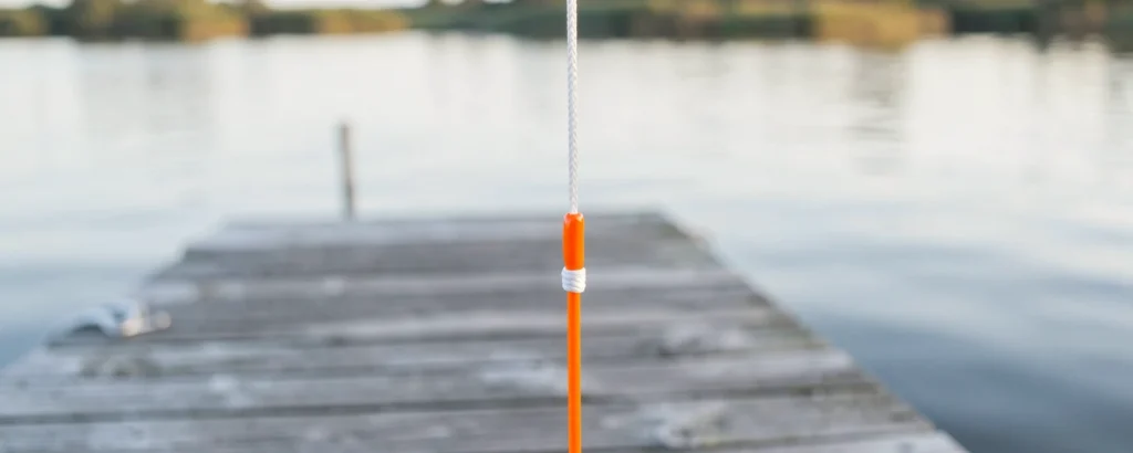 White backing joined to orange fly line with an Albright knot, over a lake dock